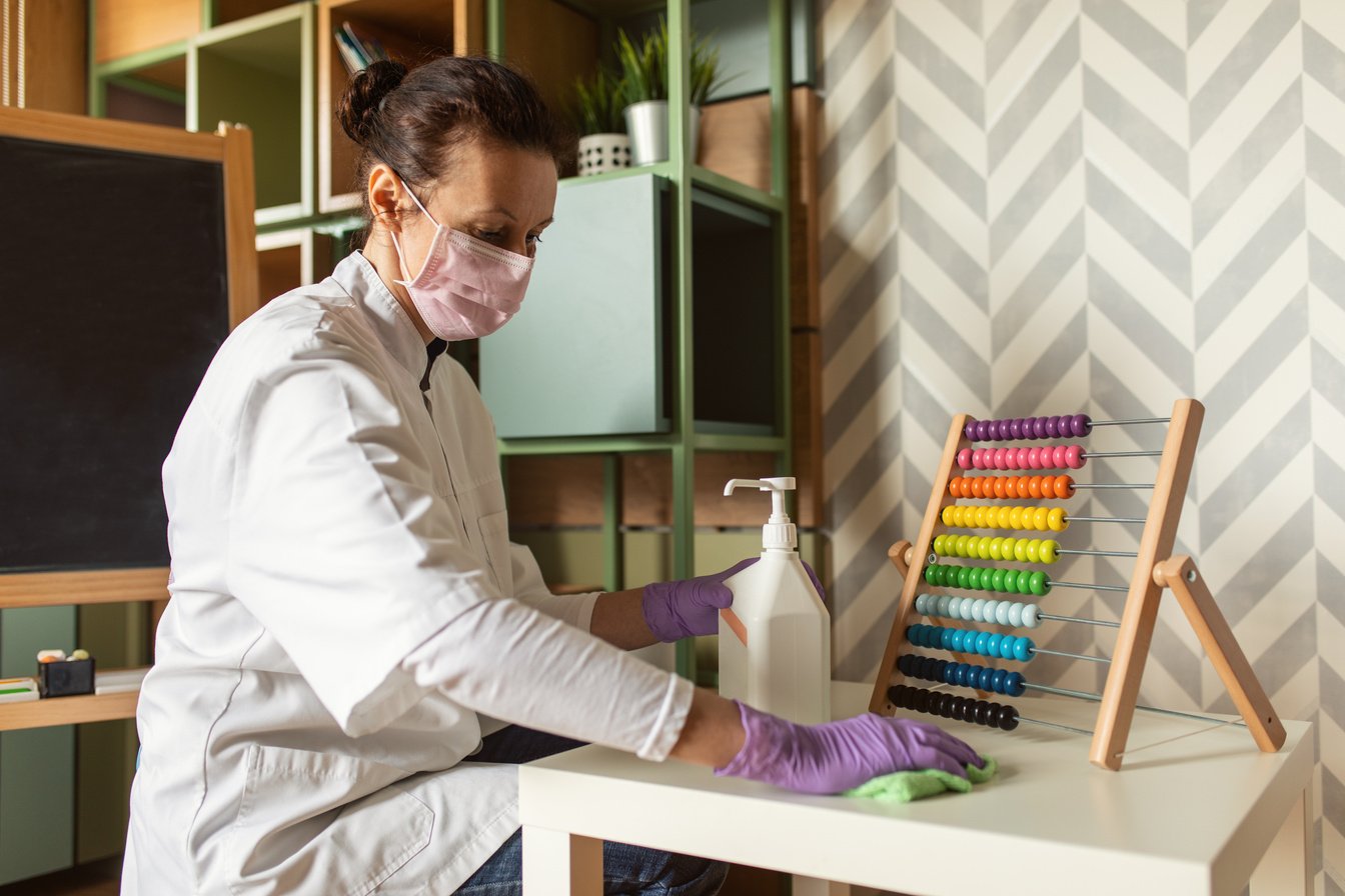 Female doctor cleaning kindergarten